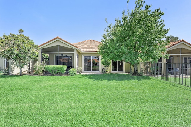 4911 Tropical Garden Dr, Boynton Beach, FL 33436 - rear view of property with a tile roof, a sunroom, and stucco siding