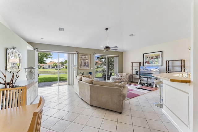 4911 Tropical Garden Dr, Boynton Beach, FL 33436 - living room with light tile patterned floors and ceiling fan