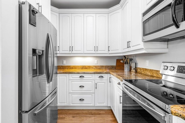 507 SW 17th St, Fort Lauderdale, FL 33315 - kitchen with appliances with stainless steel finishes, white cabinets, stone counters, and light wood-style floors