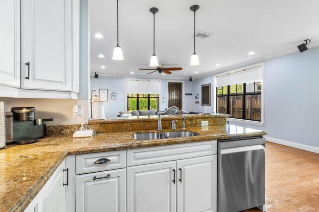 507 SW 17th St, Fort Lauderdale, FL 33315 - kitchen featuring stainless steel dishwasher, a sink, white cabinets, healthy amount of natural light, and ornamental molding