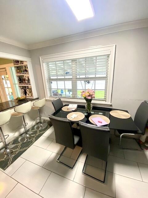 1119 S Ridge St, Lake Worth, FL 33460 - dining space with healthy amount of natural light, crown molding, and tile patterned floors