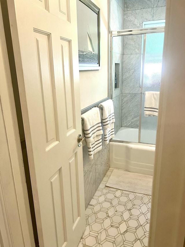 1119 S Ridge St, Lake Worth, FL 33460 - bathroom featuring shower / bath combination with glass door and tile walls