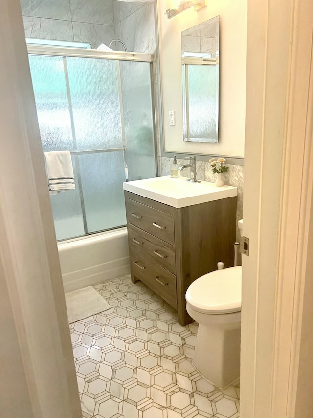1119 S Ridge St, Lake Worth, FL 33460 - bathroom with vanity, toilet, enclosed tub / shower combo, tile walls, and wainscoting