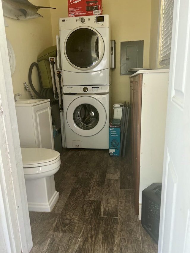 1119 S Ridge St, Lake Worth, FL 33460 - washroom with stacked washer / drying machine, electric panel, and wood finished floors