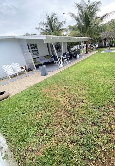 1119 S Ridge St, Lake Worth, FL 33460 - view of green lawn featuring a patio area