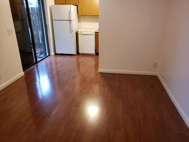 unfurnished room featuring baseboards and wood finished floors