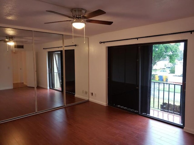 unfurnished room with a ceiling fan, wood finished floors, and baseboards