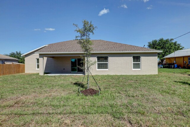 back of property with stucco siding, a patio, and a shingled roof