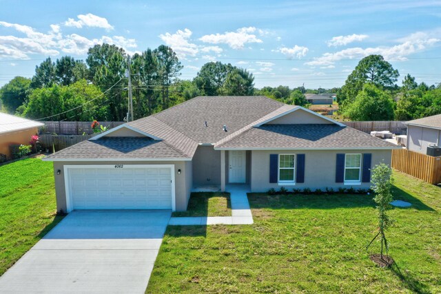 ranch-style house with a shingled roof, a garage, stucco siding, and driveway