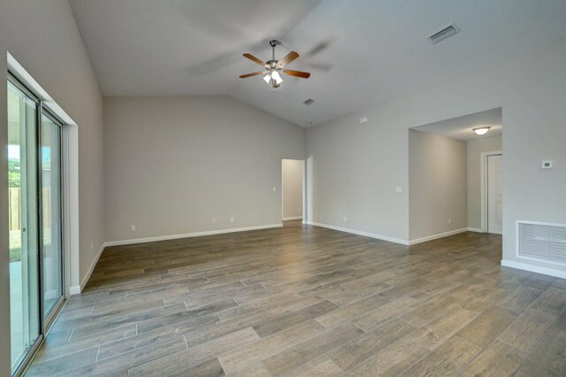 spare room with ceiling fan, wood finished floors, lofted ceiling, and baseboards