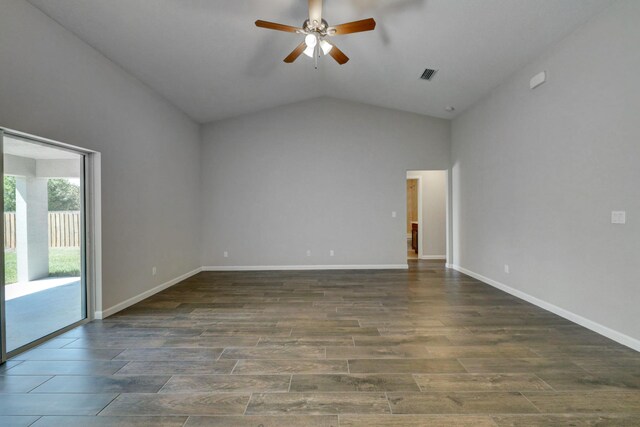 spare room with ceiling fan, lofted ceiling, wood finished floors, and baseboards