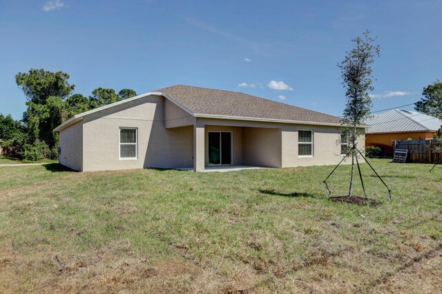 rear view of property with stucco siding