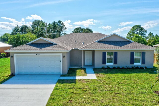 ranch-style house with a shingled roof, stucco siding, and an attached garage