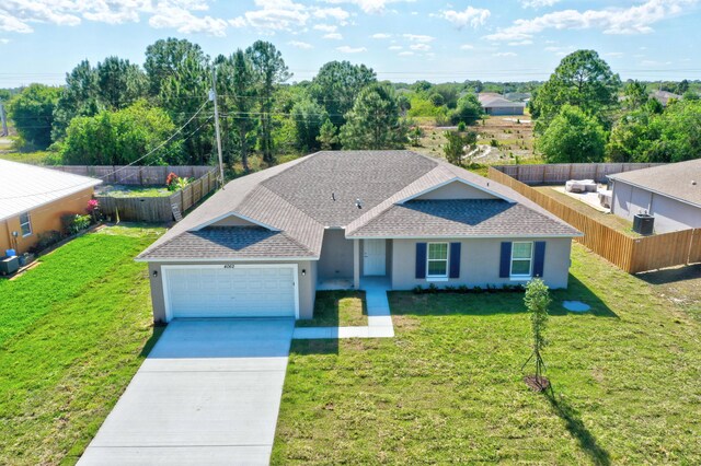 ranch-style house featuring a shingled roof, an attached garage, stucco siding, and driveway