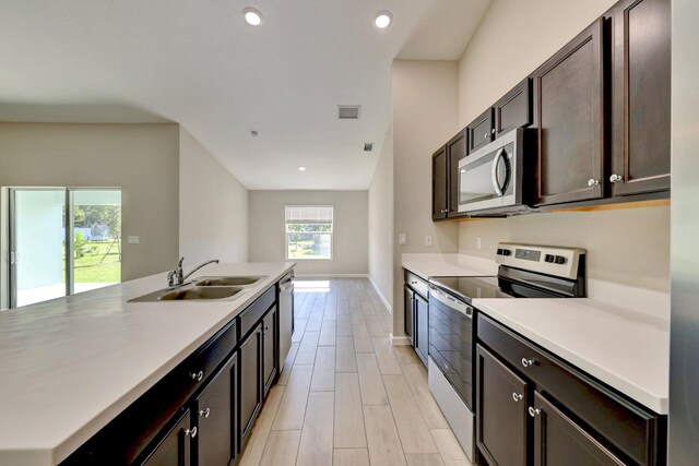 5800 NW Whitecap Rd, Port Saint Lucie, FL 34986 - kitchen featuring appliances with stainless steel finishes, a sink, recessed lighting, light countertops, and dark brown cabinetry