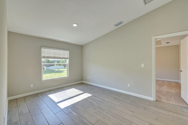 5800 NW Whitecap Rd, Port Saint Lucie, FL 34986 - spare room with light wood-style flooring, baseboards, recessed lighting, and vaulted ceiling