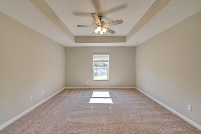 5800 NW Whitecap Rd, Port Saint Lucie, FL 34986 - spare room with a tray ceiling, ceiling fan, light carpet, and baseboards