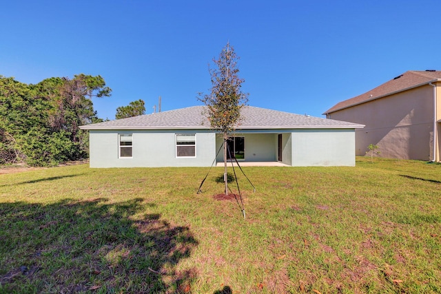 5800 NW Whitecap Rd, Port Saint Lucie, FL 34986 - rear view of property with a lawn