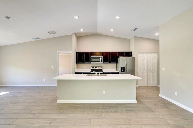 5800 NW Whitecap Rd, Port Saint Lucie, FL 34986 - kitchen with appliances with stainless steel finishes, light countertops, light wood finished floors, baseboards, and a kitchen island with sink