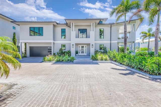 view of front of house featuring driveway, a garage, and stucco siding