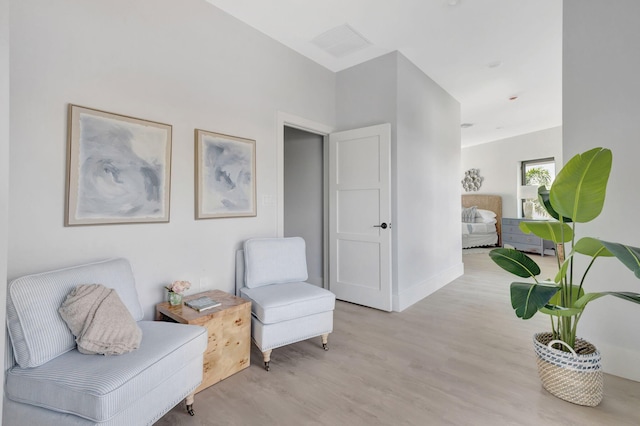 living area featuring light wood finished floors and baseboards