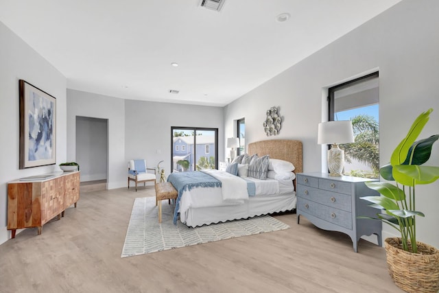 bedroom featuring light wood finished floors and baseboards