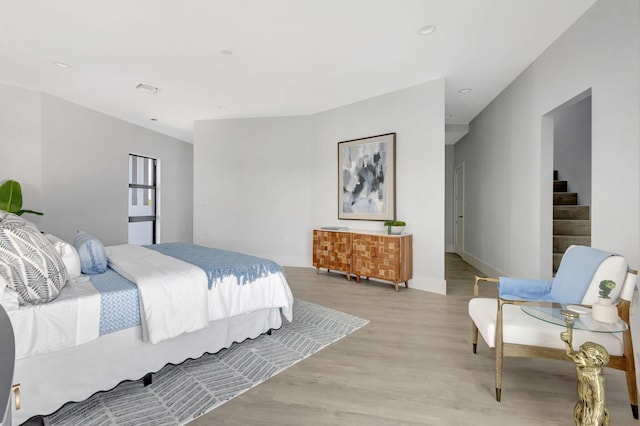 bedroom featuring light wood-style flooring, baseboards, and recessed lighting