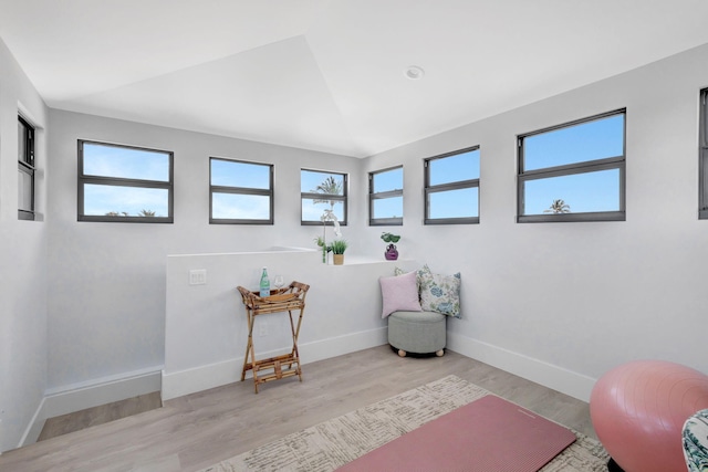 living area with baseboards and wood finished floors