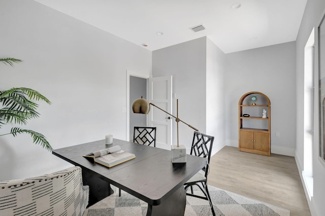 office space with light wood-style floors and baseboards