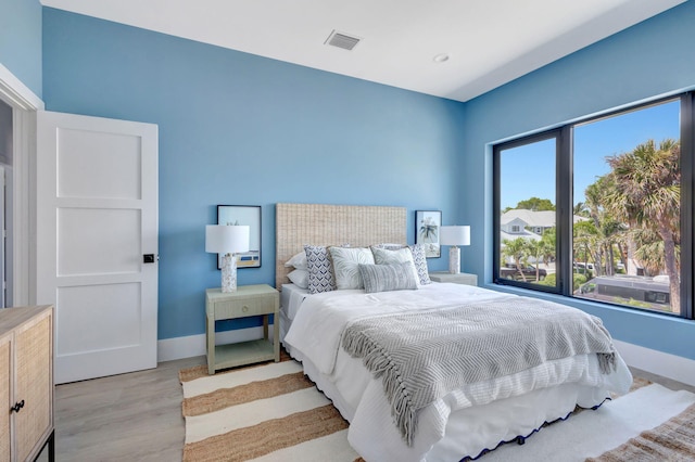 bedroom featuring wood finished floors and baseboards