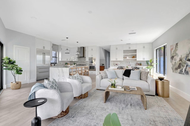 living area with light wood finished floors and baseboards