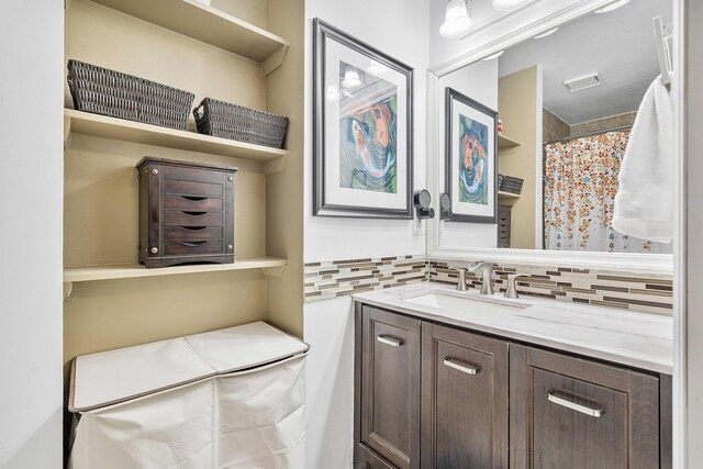 bathroom featuring backsplash and vanity