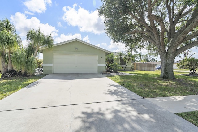 ranch-style home featuring concrete driveway, a front yard, stucco siding, and an attached garage