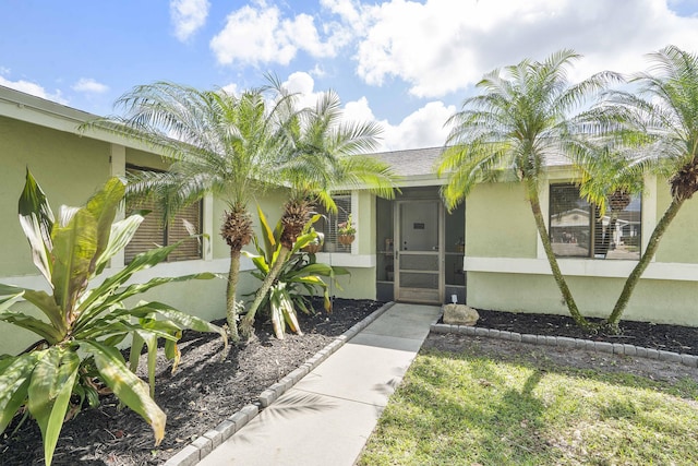 property entrance featuring stucco siding