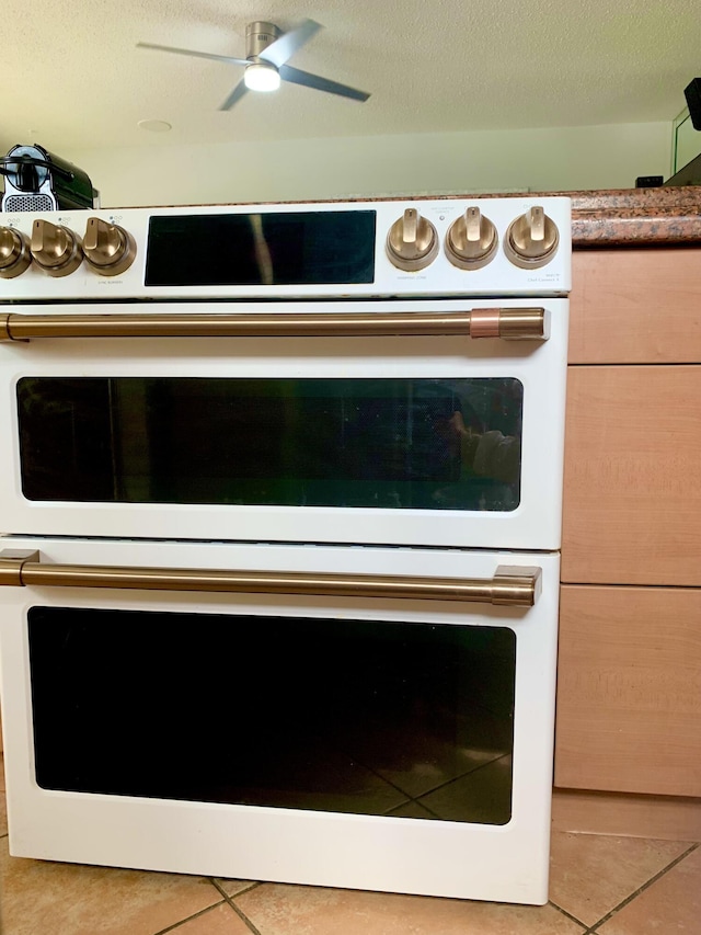 kitchen view of double oven and ceiling fan