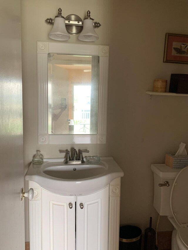 bathroom with toilet and vanity