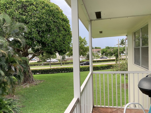 deck featuring a lawn and covered porch