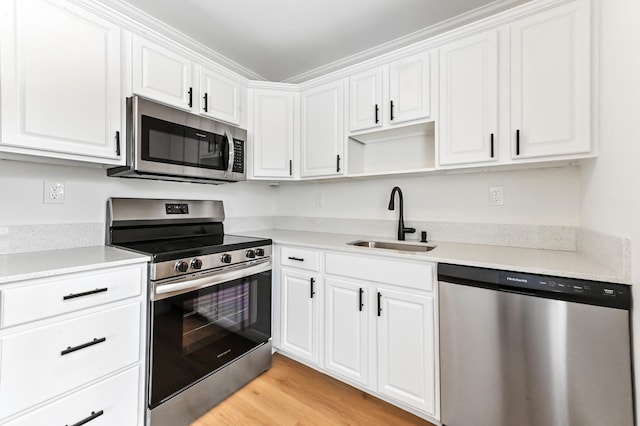 278 Normandy F, Delray Beach, FL 33484 - kitchen featuring appliances with stainless steel finishes, a sink, white cabinetry, and open shelves