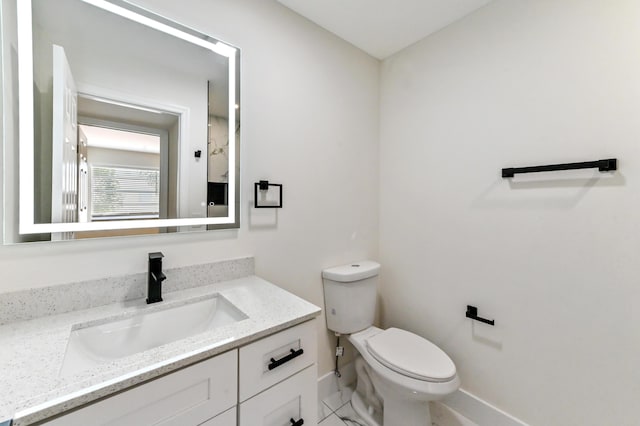 278 Normandy F, Delray Beach, FL 33484 - half bath featuring baseboards, toilet, and vanity