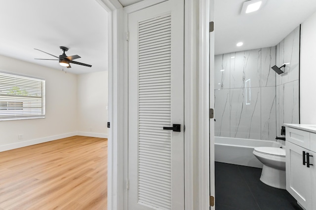 278 Normandy F, Delray Beach, FL 33484 - bathroom with ceiling fan, vanity, toilet, baseboards, and wood finished floors