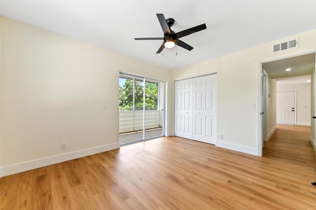278 Normandy F, Delray Beach, FL 33484 - unfurnished bedroom with baseboards, light wood-style floors, access to exterior, a ceiling fan, and a closet