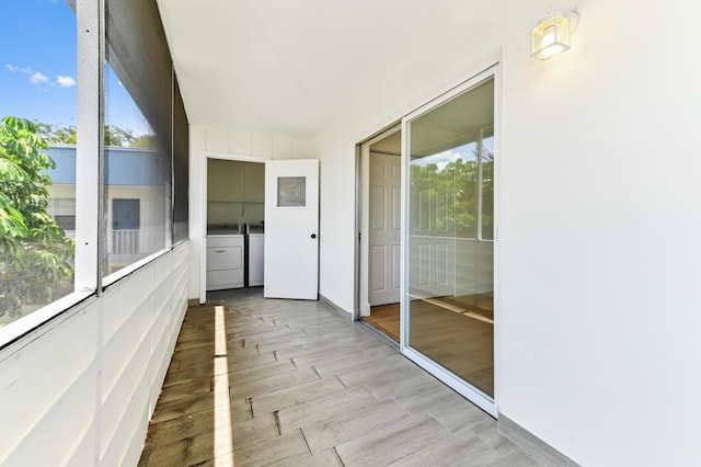 278 Normandy F, Delray Beach, FL 33484 - unfurnished sunroom featuring washer and dryer and plenty of natural light