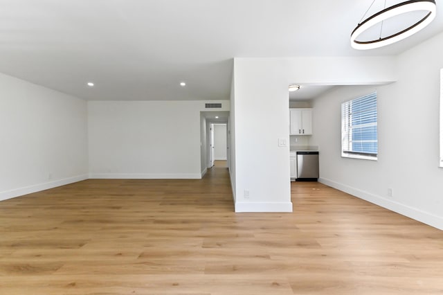 278 Normandy F, Delray Beach, FL 33484 - unfurnished living room featuring light wood finished floors, baseboards, and recessed lighting