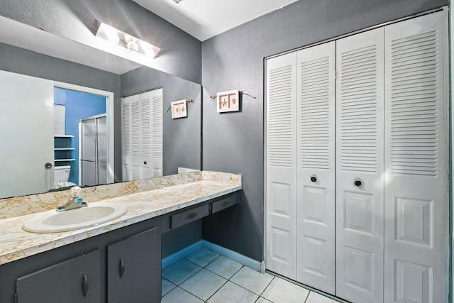 1402 SE Buckingham Ter, Port Saint Lucie, FL 34952 - bathroom featuring a closet, tile patterned flooring, vanity, and a shower stall
