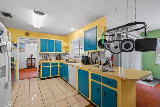 1402 SE Buckingham Ter, Port Saint Lucie, FL 34952 - kitchen with white dishwasher, a peninsula, open shelves, a sink, and light countertops