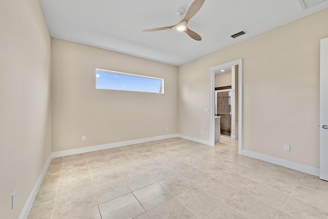 spare room with ceiling fan, light tile patterned floors, and baseboards