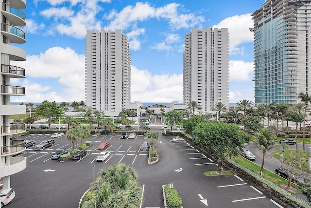 view of property featuring uncovered parking and a city view