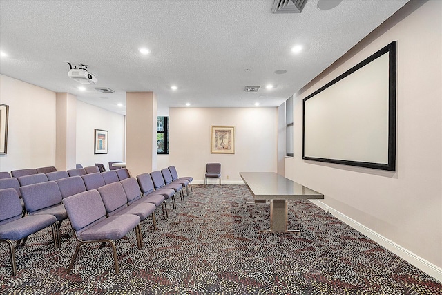 carpeted home theater room with recessed lighting, baseboards, and a textured ceiling