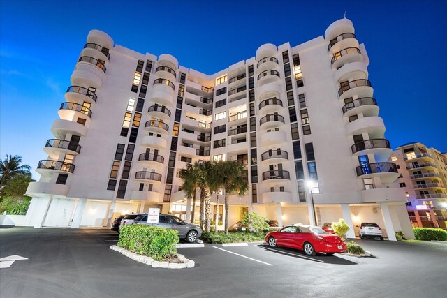 view of apartment building / complex featuring uncovered parking
