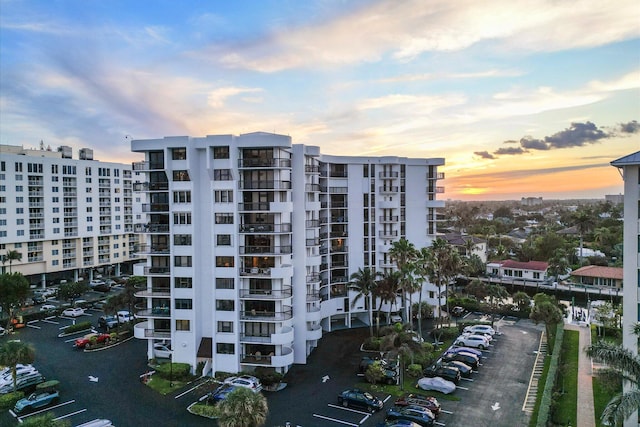 property at dusk featuring a view of apartment building / complex